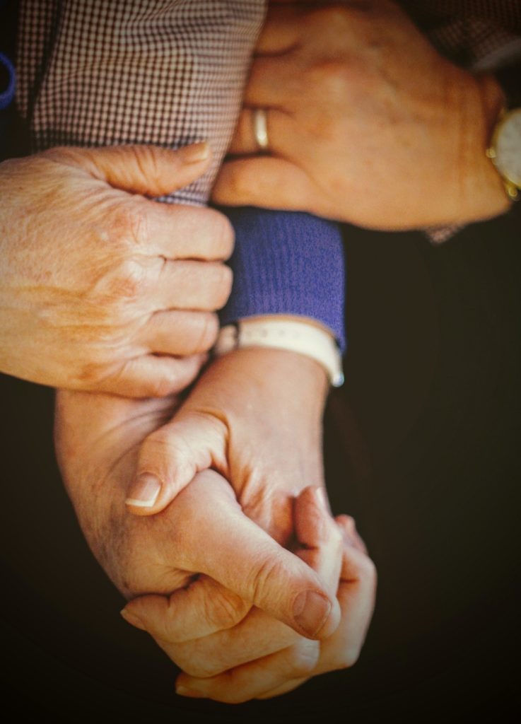 elderly couple holding hands, pursue psychedelics with proper support