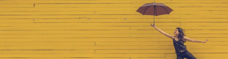 woman holding umbrella yellow background, what are the long-term effects of psychedelic use